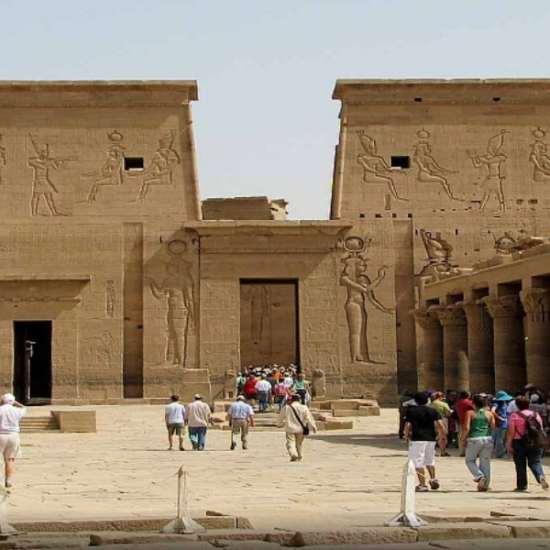 Visitors entering and leaving Philae Temple in Aswan as a part of our 6 Days Cairo, Luxor, Aswan & Abu Simbel Family Holiday
