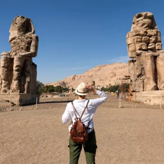 Tourist in front of the Colossi of Memnon