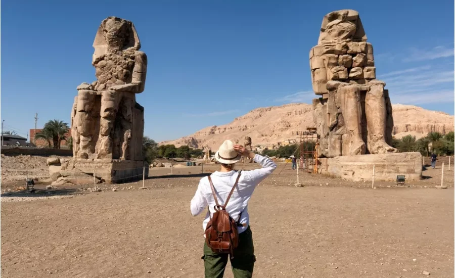 Tourist in front of the Colossi of Memnon