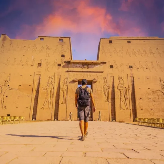 Tourist standing in front of Edfu Temple as a part of our 5 Days Nile Cruise Family Holiday from Luxor to Aswan