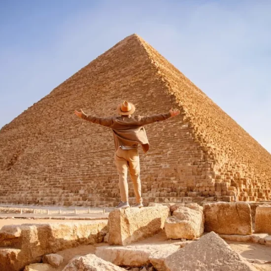 Tourist standing in front of the Great Pyramid