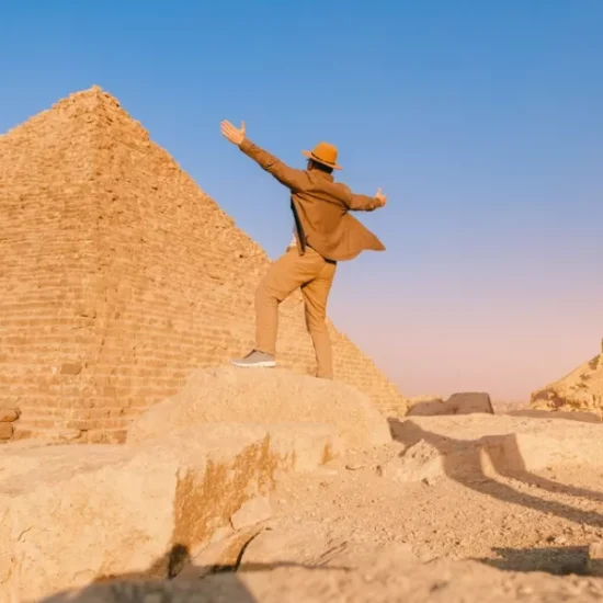 Tourist standing before Giza pyramids during our a part of our 12 Days Cairo, Nile Cruise & Sharm El Sheikh Family Tour