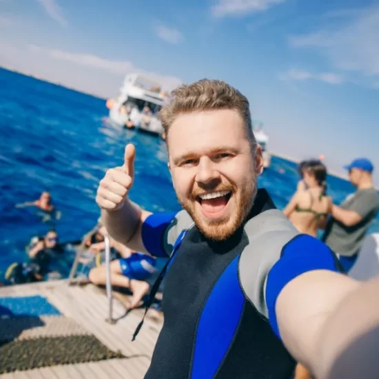Tourist taking a selfie on a diving boat