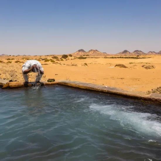 Man standing in water at Valley of Agabat