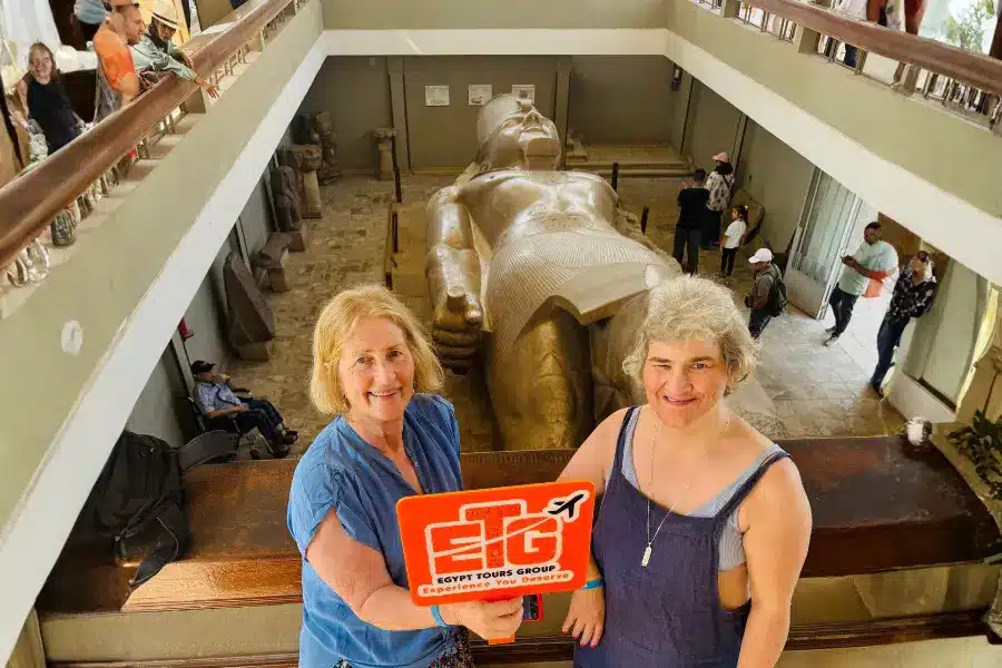 Visitors overlooking the colossal statue of Ramses II at Memphis (Mit Rahina) Open-Air Museum