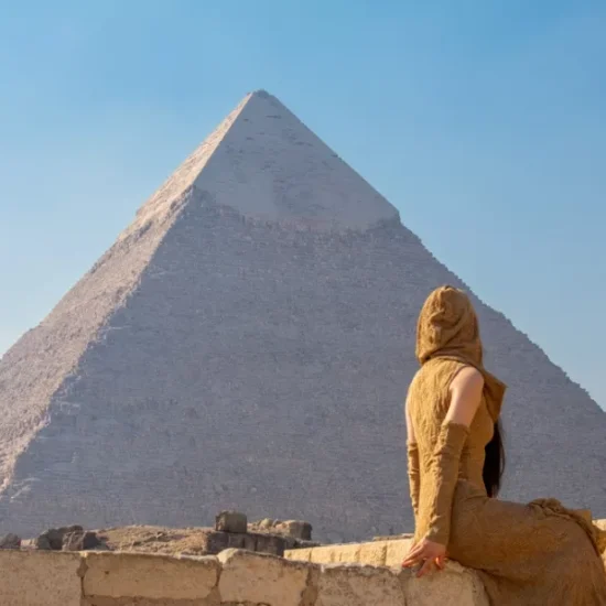 Tourist standing in front of the Great Pyramid of Khufu, part of our 7 Days Cairo, Luxor and Bahariya Oasis Family Holiday