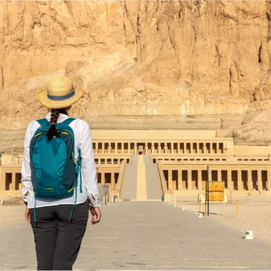 Tourist standing in front of Hatshepsut Temple from behind