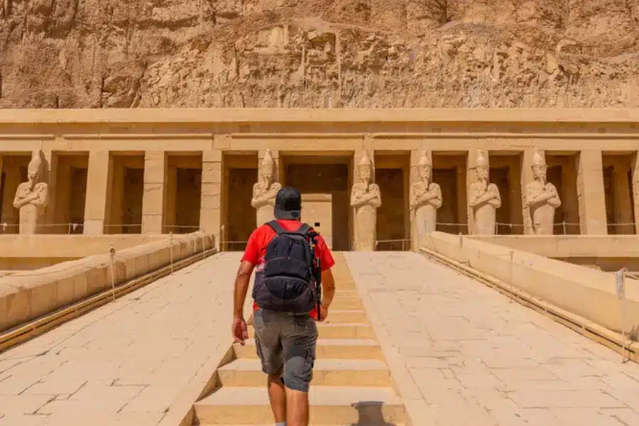 Tourist climbing Hatshepsut Temple stairs