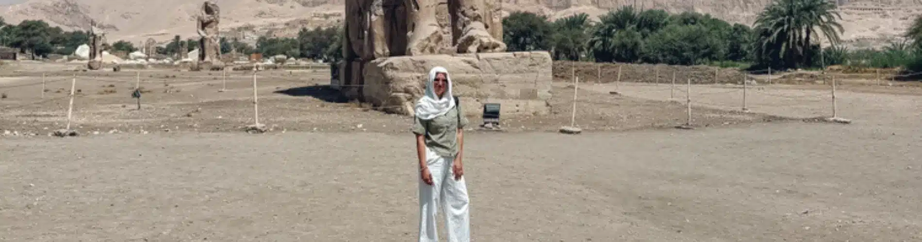 Tourist standing before Colossi of Memnon