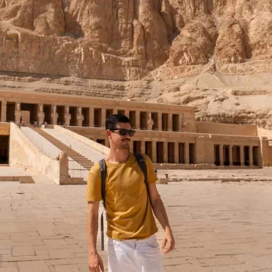 Tourist standing in front of Hatshepsut Temple, a part of our 6 Days Budget Nile Cruise Tour Package