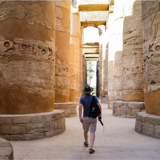 Tourist standing at Karnak Temple from behind