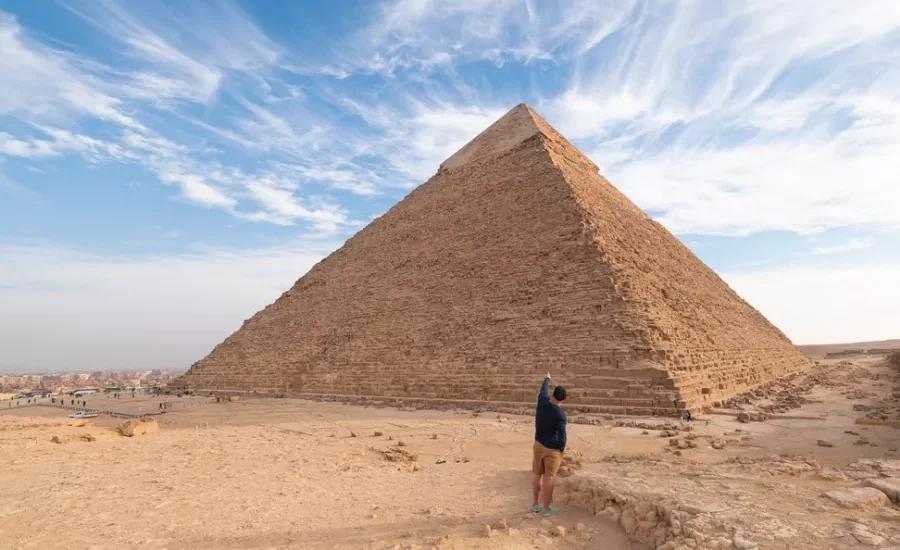 Tourist standing in front of the Great Pyramid of Giza