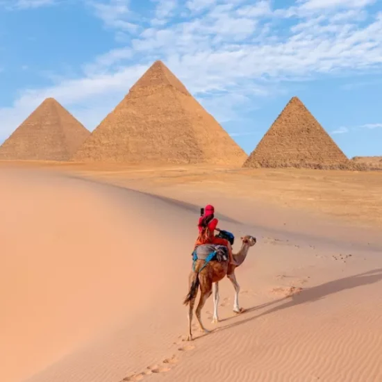 Tourist riding a horse near the Pyramids of Giza, a part of our 6 Days Budget Nile Cruise Tour Package from Cairo