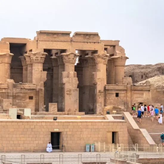 Tourists standing at Kom Ombo Temple in Aswan