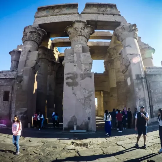 Tourists standing at Kom Ombo Temple in Aswan
