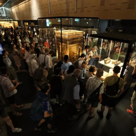 Tourists gathered around statues in the Grand Egyptian Museum