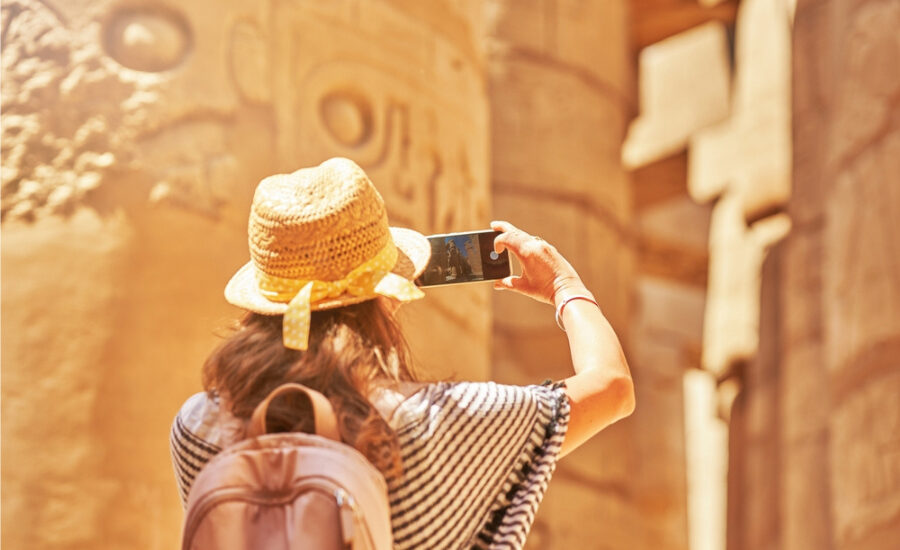 Tourist taking photos at Karnak Temple, 9 Days Cairo, Luxor & Hurghada Budget Tour