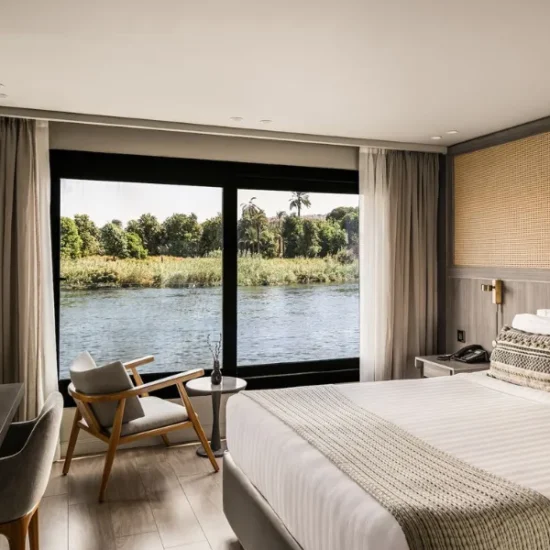 Historia Nile Cruise cabin with a large window overlooking the Nile River
