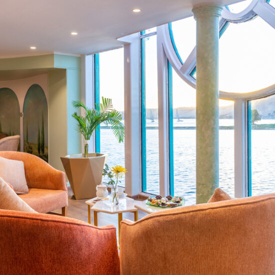 Outdoor seating area with Nile views aboard the cruise