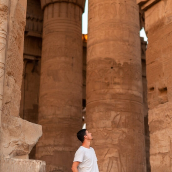 Tourist looking at the columns inside Luxor Temple