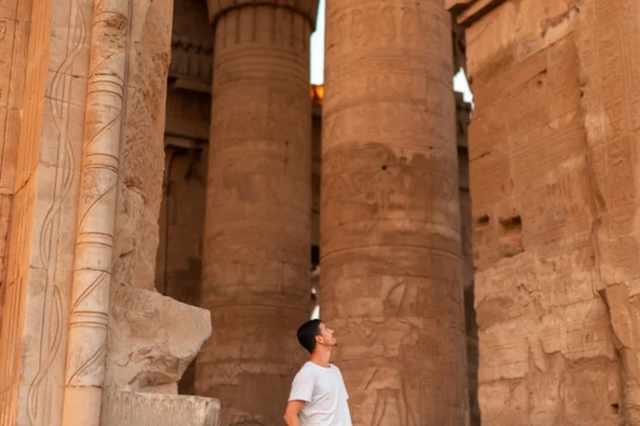 Tourist looking at the columns inside Luxor Temple